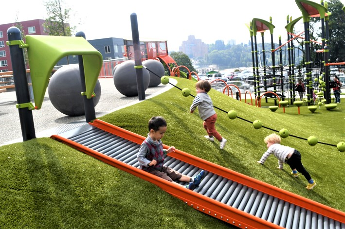 a group of children playing in a playground