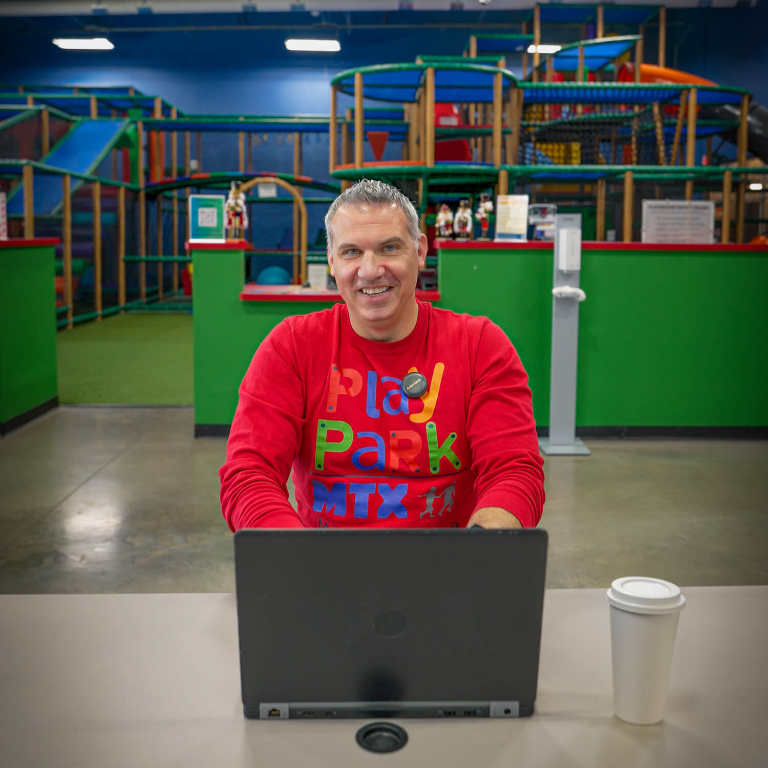 indoor playground with secure wifi with parent working on laptop