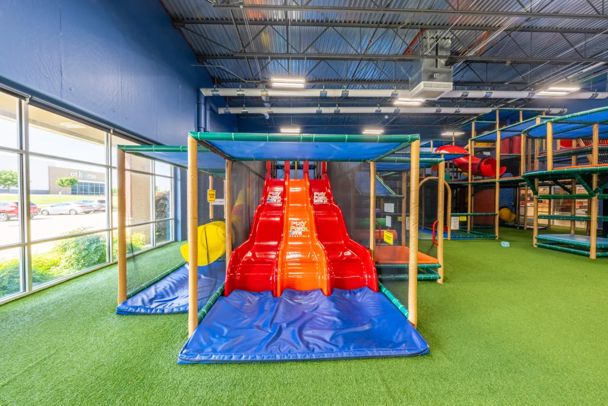 Red multi-lane slides inside Play Park MTX.